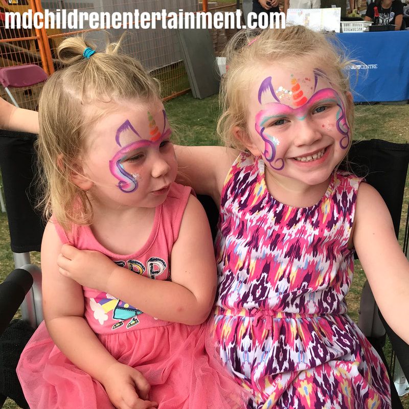 Face painted sisters with unicorns! Want to hire an excellent face painter? We serve Toronto, Newmarket, Barrie and gta!