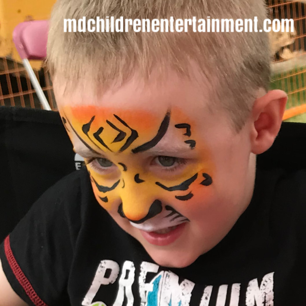 Tiger face painted boy! Hire us for kids birthday parties, corporate events and more in Toronto!