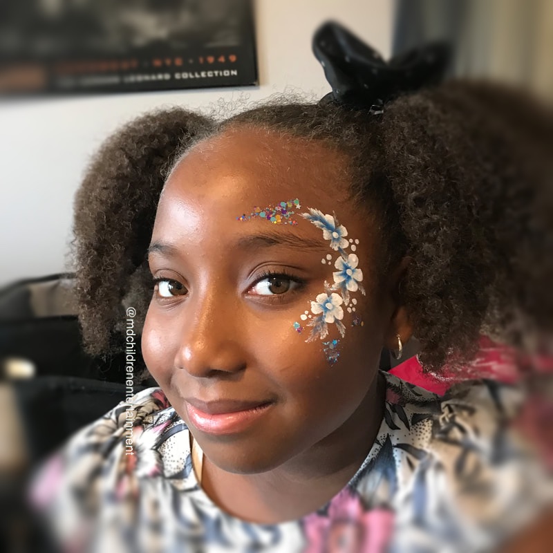 Flower face painting on a beautiful girl! Hire us in Bradford, Newmarket, Vaughan, Markham, Toronto and gta